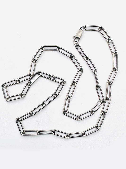 The JMNYC Designs 18" Sterling Silver Rhodium Plated Medium Paperclip Chain is laid out on a white background.