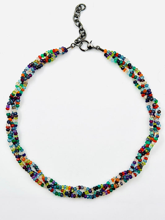 JMNYC Designs 18" Triple Strand Faceted Multi Stone Necklace, featuring small faceted multicolor beads and a black adjustable chain clasp, shown against a white background.