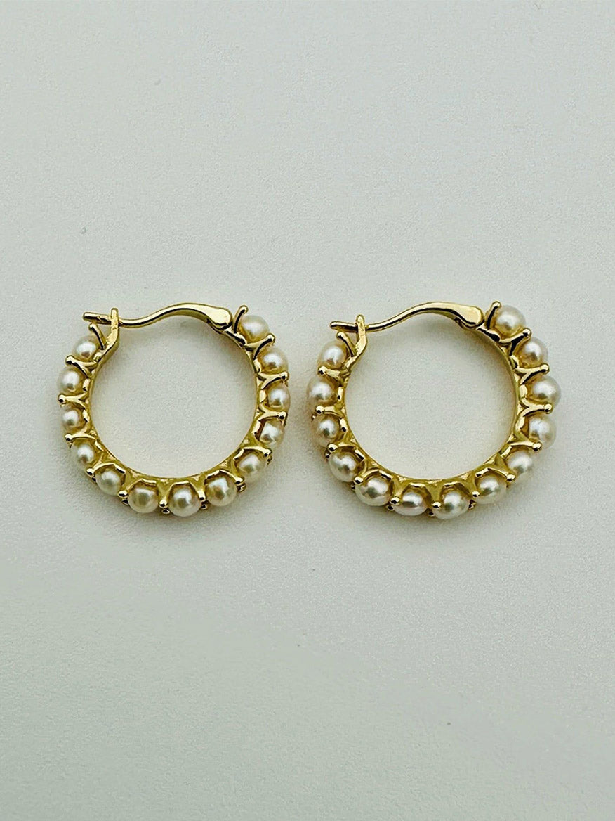 The JMNYC Designs 20mm Freshwater Pearl Hoop Earring with Gold Vermeil features a pair of gold vermeil hoops adorned with small white freshwater pearls evenly spaced around the 20mm outer edge, set against a simple light background.
