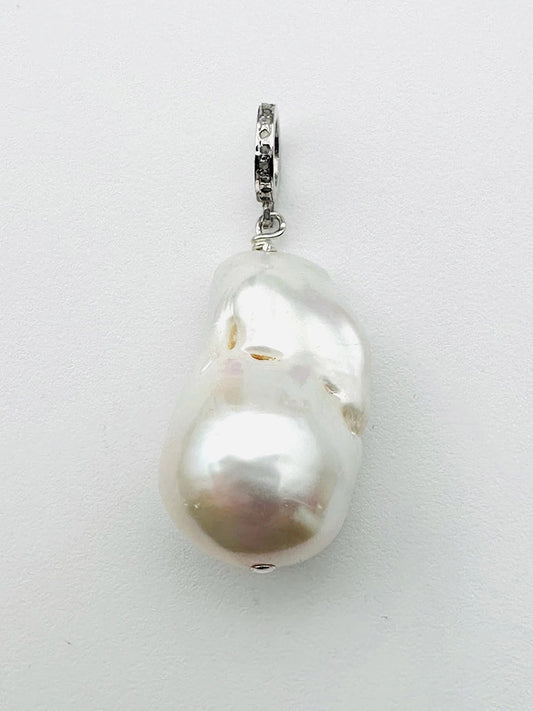 A JMNYC Designs Baroque Pearl Sterling Silver Diamond Pendant featuring an irregularly shaped white baroque pearl attached to a sterling silver bail, showcased against a plain white background.