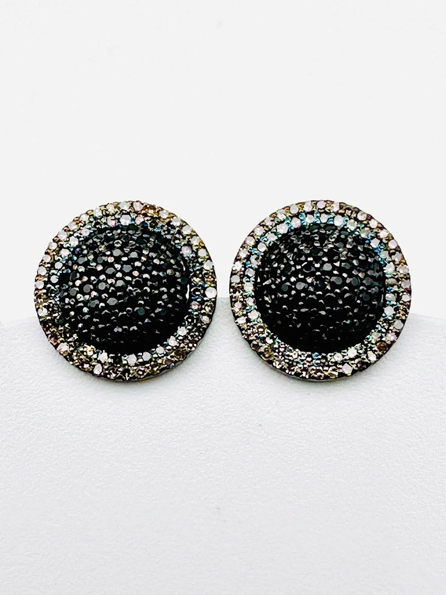 The JMNYC Designs Black Diamond & White Diamond Halo Stud Earrings feature round, black diamonds accented by shimmering white stones set in concentric circles. Crafted in sterling silver, these earrings elegantly blend classic white diamond halos with striking black details for a sophisticated look.