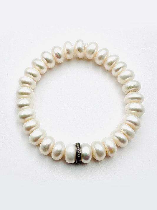 The JMNYC Designs Freshwater Button Pearl Bracelet features luminous white pearls and a sterling silver & diamond rondelle accent bead.