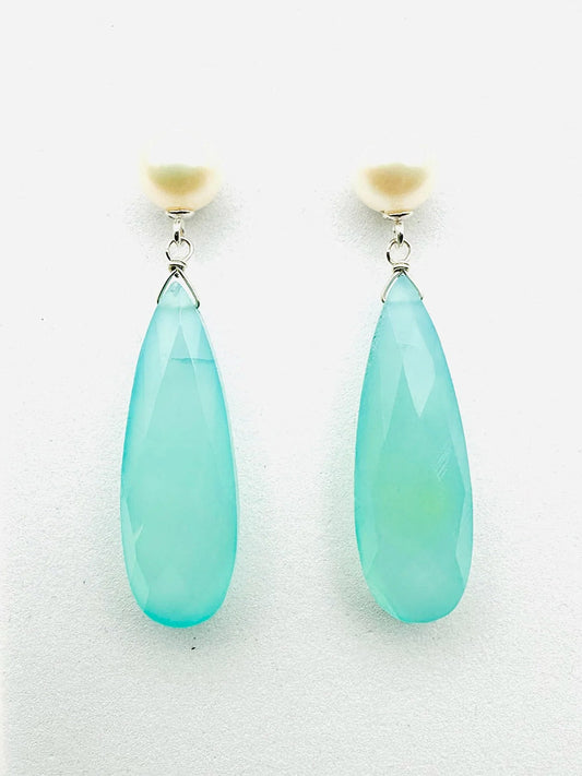 JMNYC Designs earrings feature round white freshwater pearl studs with elongated, faceted turquoise-colored chalcedony teardrop pendants.