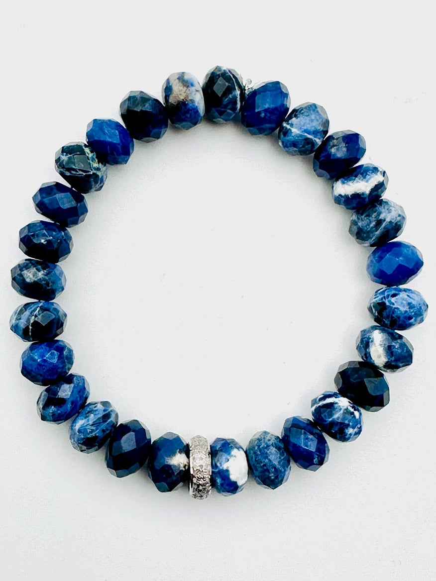 JMNYC Designs Faceted Sodalite Rondell Bracelet with Sterling Silver Triple Diamond Row Rondelle, featuring blue and white faceted gemstone beads accented by a single textured sterling silver triple diamond row rondelle, displayed on a white background.