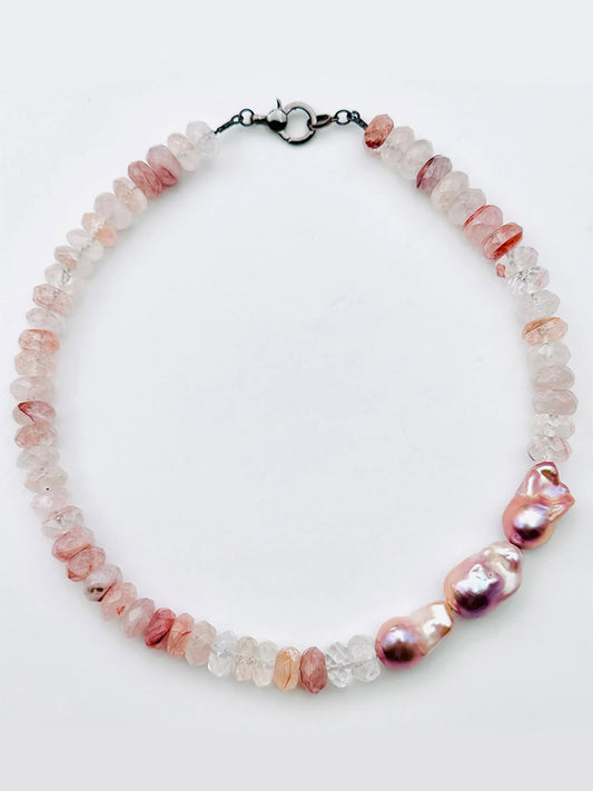 Certainly! Here is a rewritten sentence using your provided product data: The JMNYC Designs Faceted Strawberry Quartz Rondell & Natural Baroque Pearl Necklace features pink and clear faceted stones reminiscent of strawberry quartz, accented by three large, irregular pink baroque pearls and finished with a sleek silver clasp.