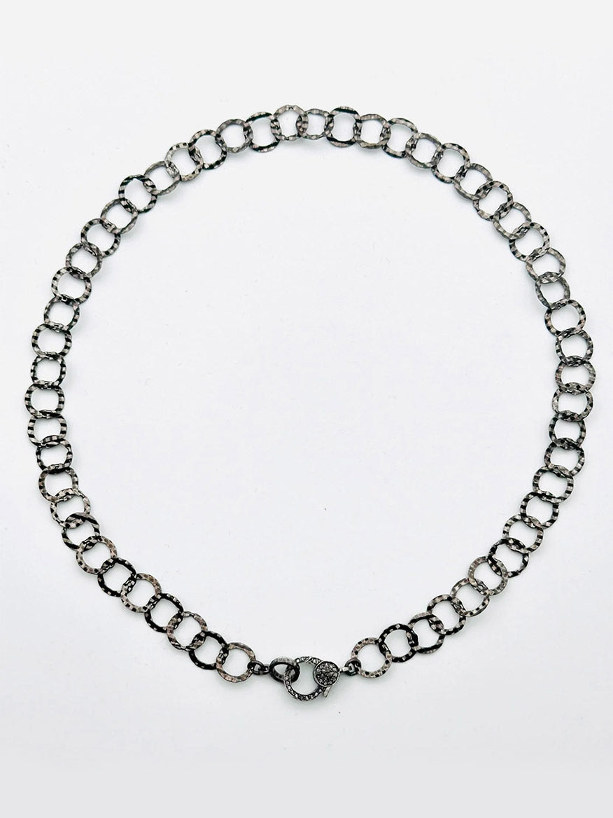 The JMNYC Designs Sterling Silver Rhodium Hammered Round Link Chain Necklace with Diamond Clasp, 18", is displayed in a circular shape on a plain white background.