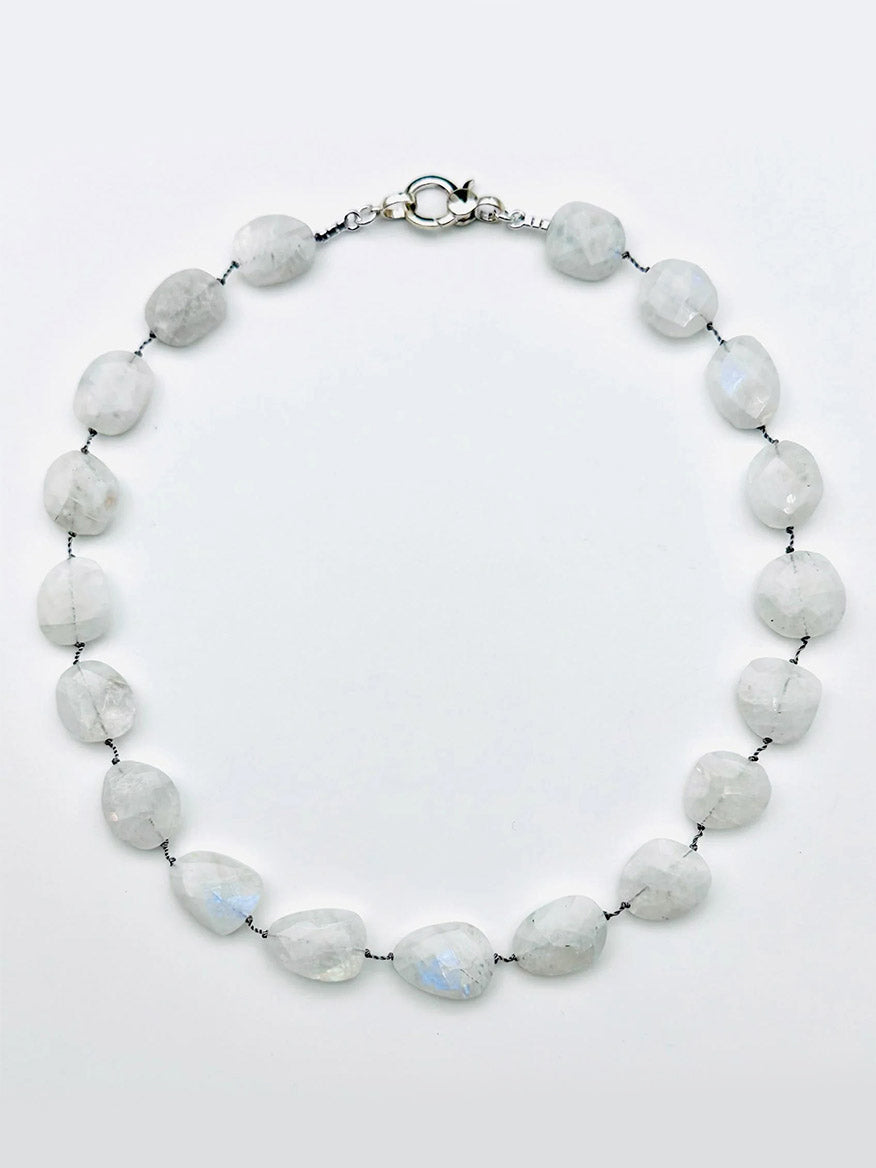 JMNYC Designs Medium Flat Faceted Rainbow Moonstone Necklace features irregularly shaped, translucent white rainbow moonstones, evenly spaced along a strand and finished with a sterling silver clasp.