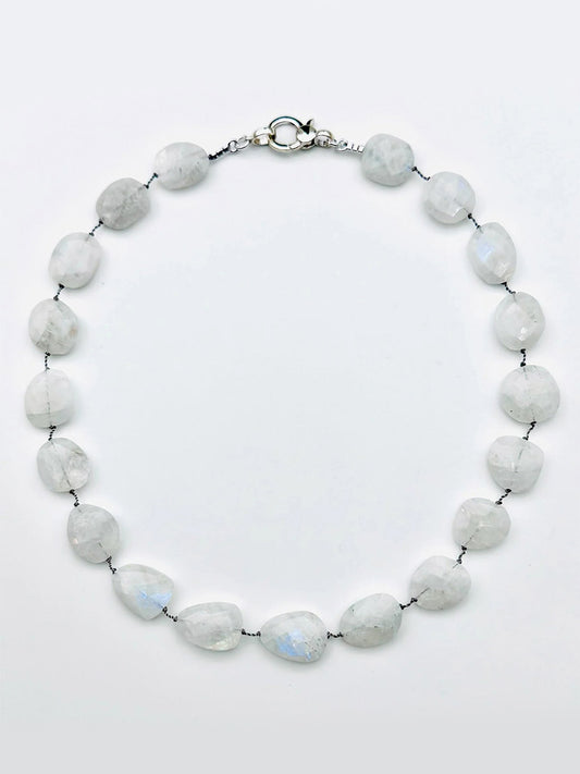 JMNYC Designs Medium Flat Faceted Rainbow Moonstone Necklace features irregularly shaped, translucent white rainbow moonstones, evenly spaced along a strand and finished with a sterling silver clasp.