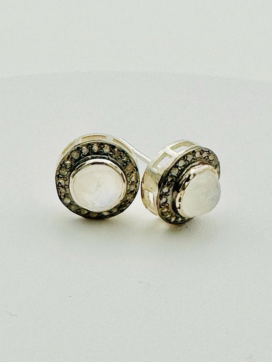 JMNYC Designs Rainbow Moonstone & Diamond Stud Earrings feature a central Rainbow Moonstone encircled by diamonds, set in polished sterling silver for a timeless, elegant look.