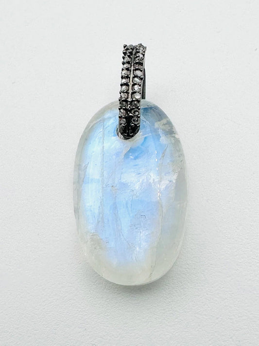 JMNYC Designs Oval Rainbow Moonstone Cabochon & Diamond Pendant features an oval cabochon moonstone with a pavé-set black metal bail, shown against a plain white background.