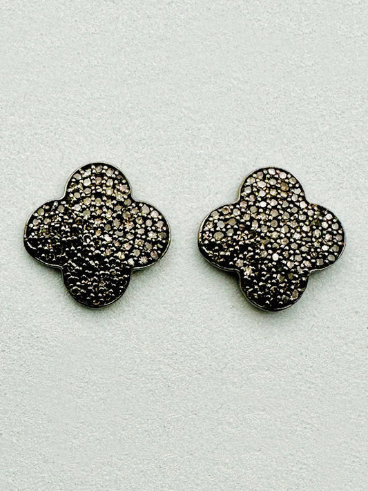 The JMNYC Designs Pave Diamond Clover Post Earring features a .5" rhodium sterling silver quatrefoil shape adorned with sparkling pave diamonds, displayed against a light background.