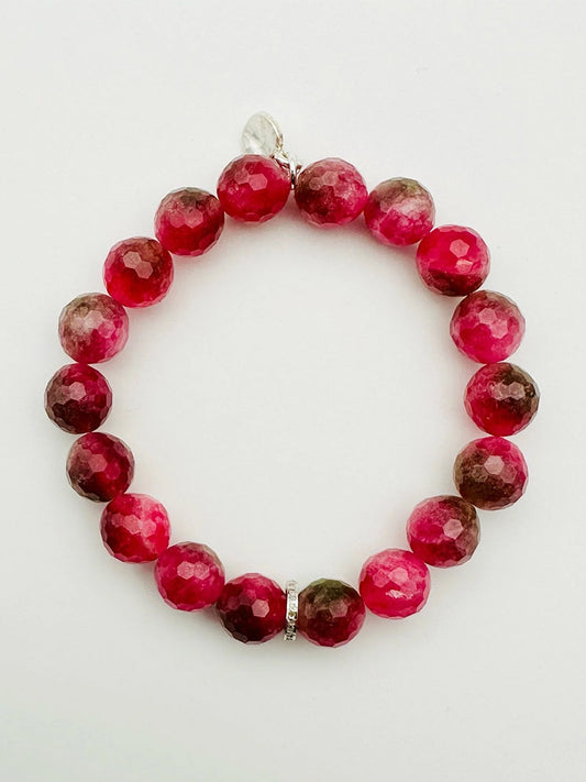 A JMNYC Designs Pink Tourmaline Bracelet with diamond and sterling silver accents is displayed on a white background.