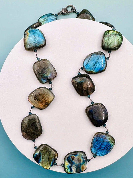 The JMNYC Designs Smooth Organic Shaped Labradorite Necklace With Diamond Lock Clasp 19" features large, polished labradorite stones with blue-green iridescence and a secure sterling silver diamond lock clasp.