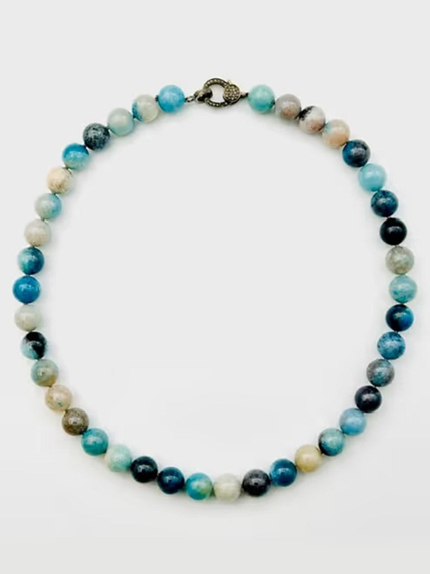 The JMNYC Designs Trolleite Ball Necklace with Sterling Silver Diamond Clasp features round blue, white, and gray stones arranged in a graceful gradient pattern, fastened with a sleek sterling silver diamond clasp.