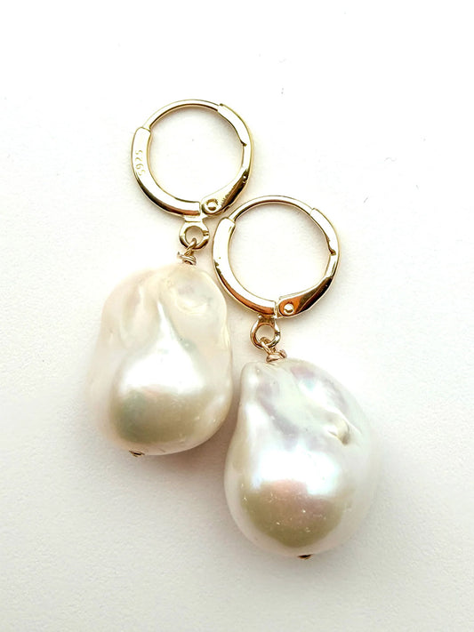 JMNYC Designs White Freshwater Baroque Pearl Earrings each showcase a large, irregularly shaped baroque pearl drop on a vermeil simple huggie leverback, measuring 1.5 inches and displayed against a white background.