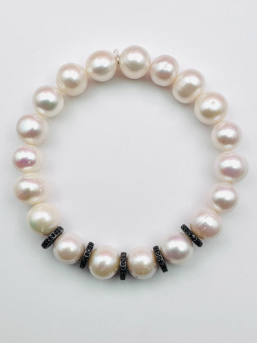 A JMNYC Designs White Freshwater Edison Pearl Bracelet with Black Spinel & Rondelles is displayed on a plain white background.