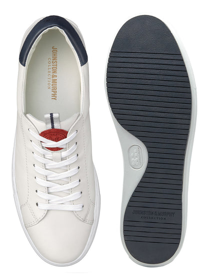 Top view of a J & M Collection Anson Lace-to-Toe in White Sheepskin sneaker next to its upside-down sole, displaying the interior and tread design.