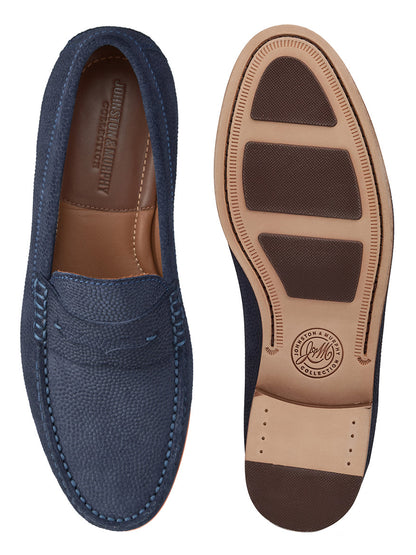 A pair of J & M Collection Baldwin Penny loafers in Navy English Suede featuring slip-on design and stitched details, with one shoe facing up to reveal the sole and the other facing down to showcase the top.