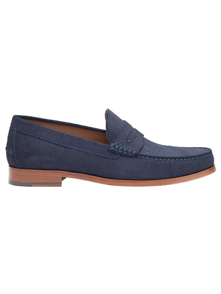 The J & M Collection Baldwin Penny in Navy English Suede features a textured fabric with visible stitching, a brown sole, and is viewed from the side as a handsewn moccasin with a refined leather lining for added comfort.