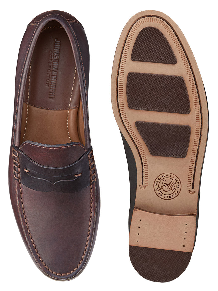 A pair of the J & M Collection Baldwin Penny in Dark Brown English Full Grain loafers viewed from the top and bottom. The top view shows handsewn moccasin stitching details, while the bottom view displays the textured sole with rubber grips.