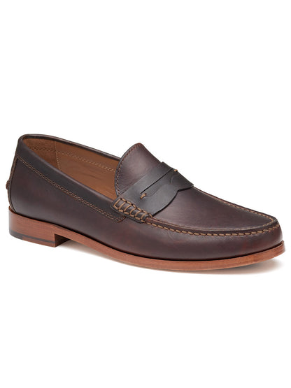 Introducing the J & M Collection Baldwin Penny in Dark Brown English Full Grain: a meticulously crafted penny loafer featuring detailed stitching, a low wooden heel, and a cushioned footbed.