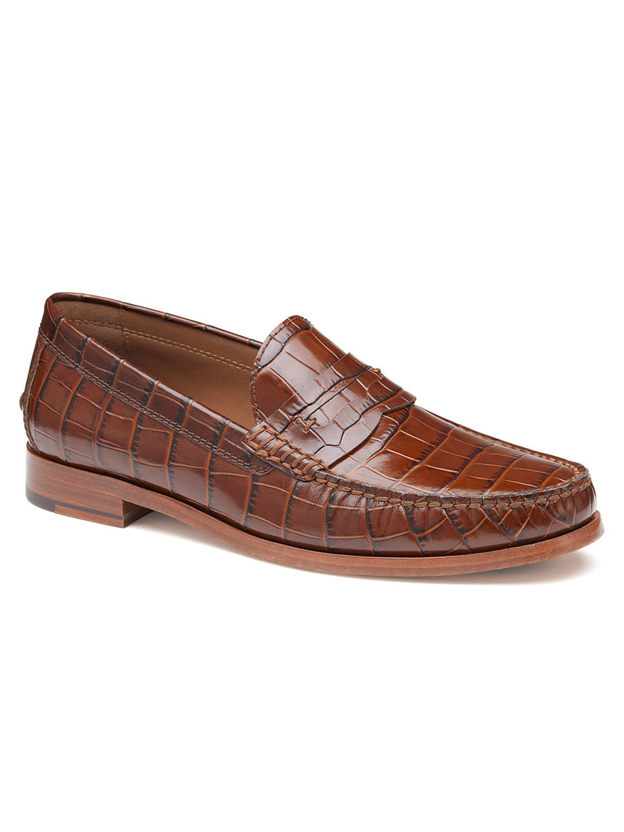 The J & M Collection Baldwin Penny in Mahogany Croc Print Calfskin is a handsewn moccasin-style loafer featuring a luxurious crocodile skin pattern and a low wooden heel.