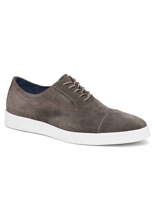 The J & M Collection Bolivar Cap in Grey Italian Suede is a casual shoe with a white rubber sole, featuring a lace-up design, rounded toe, and Italian suede. It also boasts a soft leather lining for added comfort.