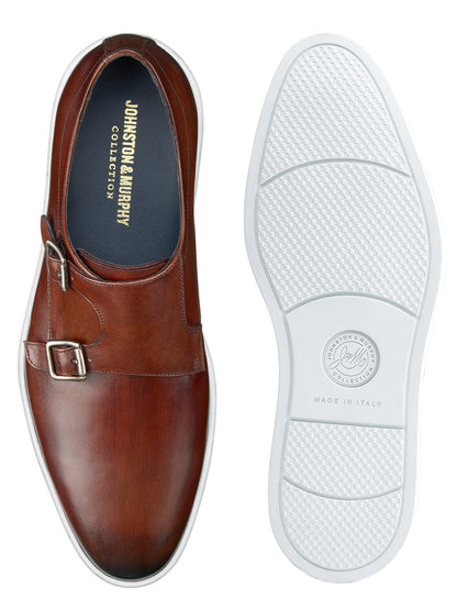 Brown Italian calfskin double monk strap dress shoe with a white rubber sole. The top view highlights the shoe's buckle detail, leather lining, interior branding, and sole pattern. Text inside reads, "J & M Collection Bolivar Monk Strap." Enhanced cushioning ensures all-day comfort.