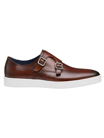 The J & M Collection Bolivar Monk Strap in Brown Italian Calfskin is a pair of brown leather double monk strap shoes with a white sole, featuring two metal buckle closures on the side and enhanced cushioning for added comfort.