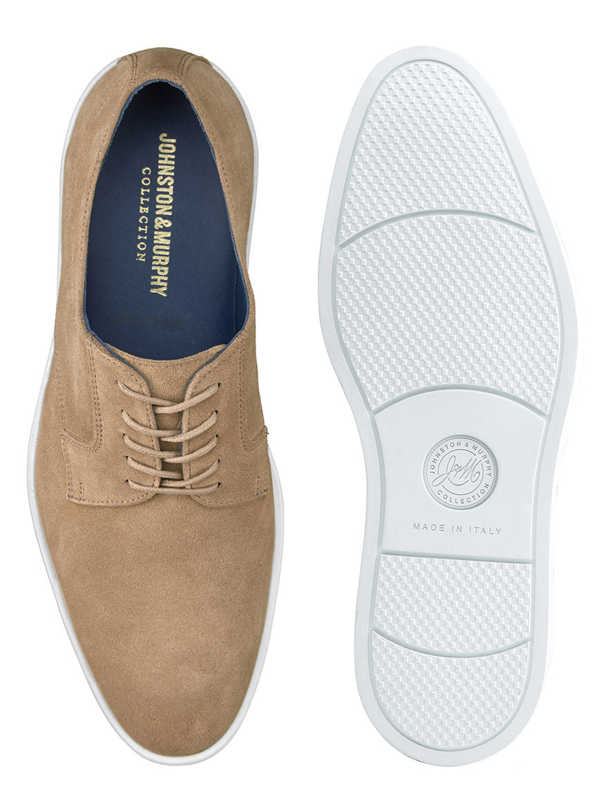 The J & M Collection Bolivar Plain Toe in Taupe Italian Suede, shown from both the side and sole, features the Johnston & Murphy logo inside and on the white rubber sole. The shoes are marked "Made in Italy" and boast full leather lining for added comfort.