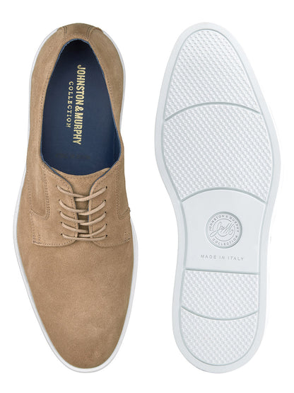 The J & M Collection Bolivar Plain Toe in Taupe Italian Suede, shown from both the side and sole, features the Johnston & Murphy logo inside and on the white rubber sole. The shoes are marked "Made in Italy" and boast full leather lining for added comfort.