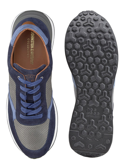 The J & M Collection Briggs Perfed Lace-Up in Navy/Grey/Blue Italian Suede/Calf shows one shoe from a top view and the other displaying the sole. Crafted from premium Italian suede and calf leather, these sneakers feature blue, gray, and brown tones. They boast a textured hexagonal pattern on the sole and ensure comfort with their advanced EVA outsole.