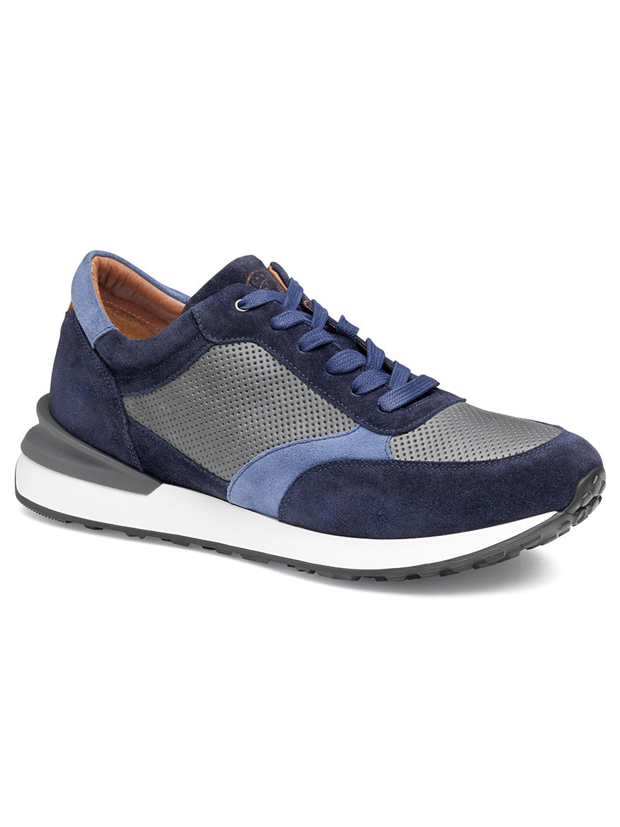 The J & M Collection Briggs Perfed Lace-Up in Navy/Grey/Blue Italian Suede/Calf is an athletic sneaker featuring a perforated toe area, blue laces, a white sole, and an EVA outsole for added comfort.