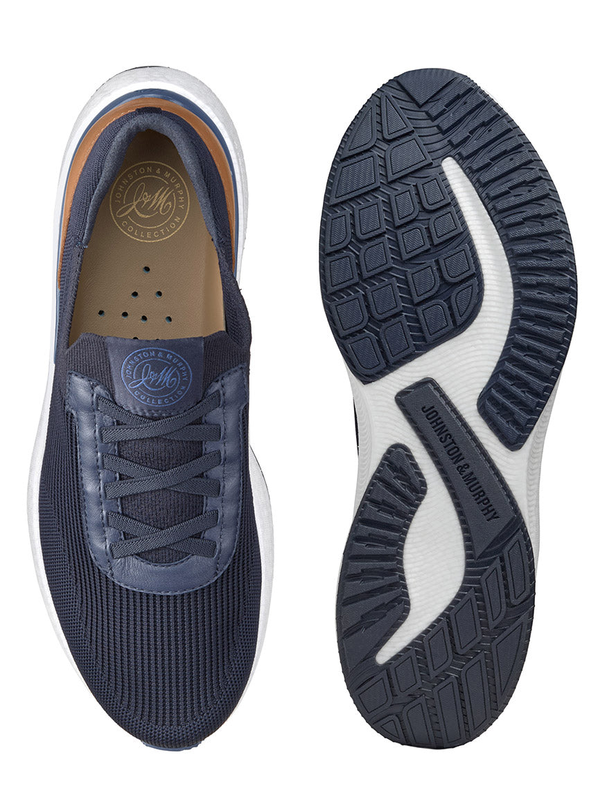 Top and bottom view of the J & M Collection Briley Knit Jogger in Navy Knit, showcasing a dark blue athletic shoe with a white sole. The brands "Johnston and Murphy" and "Golf" appear on the inner sole and outer sole, respectively. Featuring knit uppers for breathability, these shoes also incorporate a POWERFOAM midsole for added comfort.