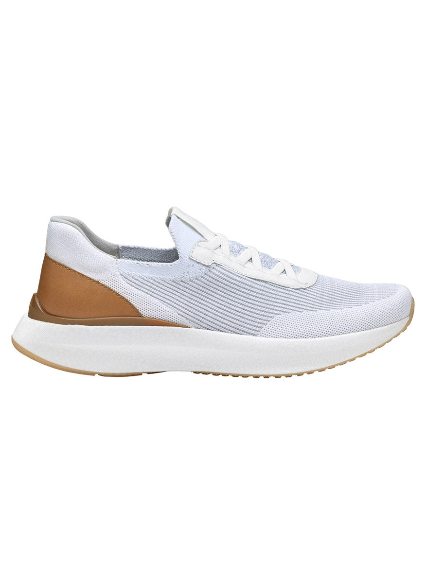 The J & M Collection Briley Knit Jogger in White Knit is a white and light brown athletic shoe featuring knit uppers, a white sole, and includes white laces, a cushioned heel, and a memory-foam footbed for ultimate comfort.