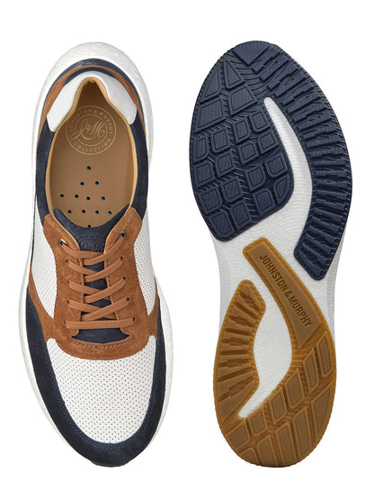 A pair of J & M Collection Briley Perfed Joggers in Navy Multi Suede/Full Grain, showing the top view with white, navy, and brown colors, featuring a suede leather upper and the bottom view with a patterned rubber sole.