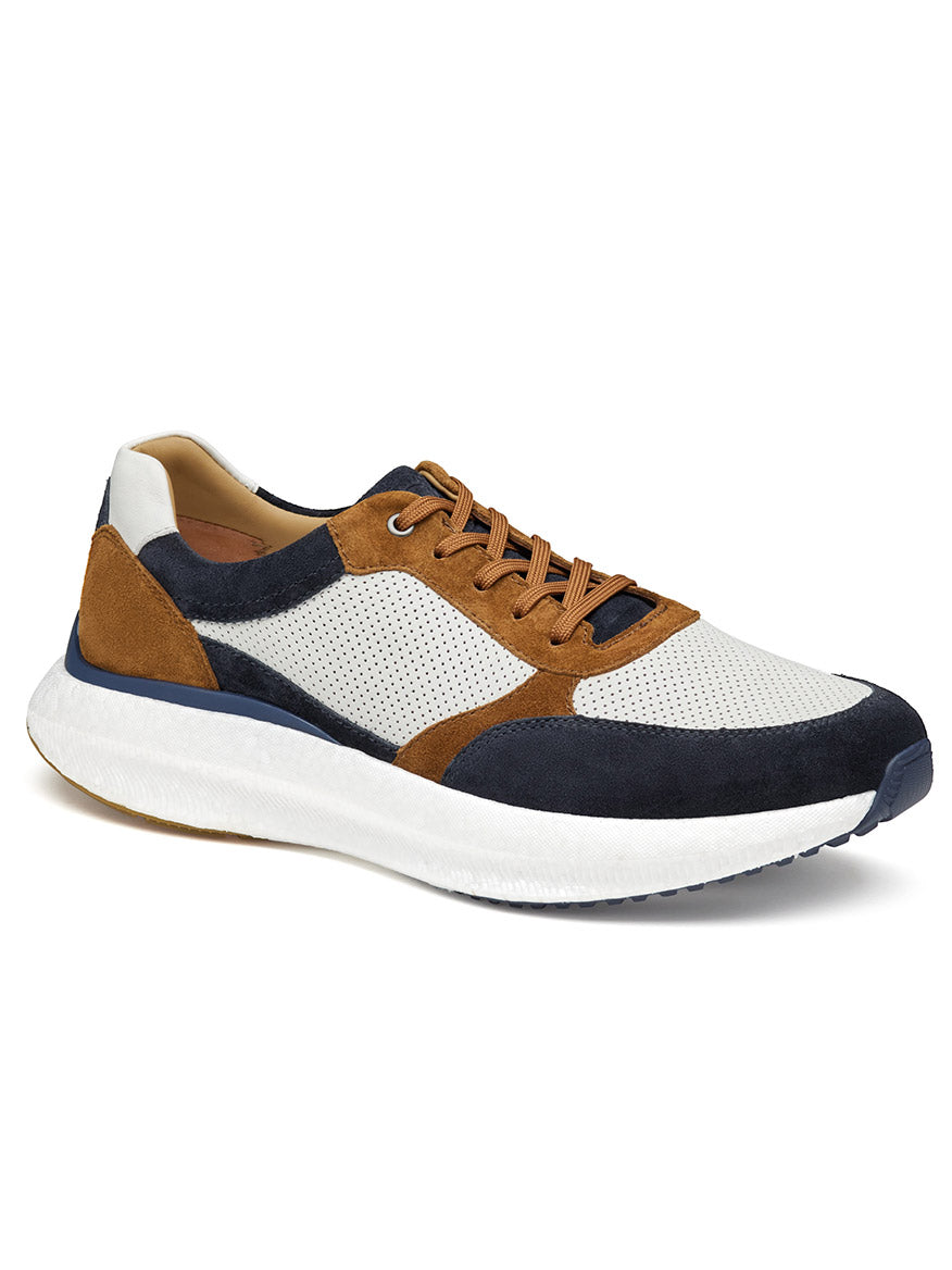 A single J & M Collection Briley Perfed Jogger in Navy Multi Suede/Full Grain, featuring a white perforated upper, black and brown suede accents, tan laces, and a thick white sole with a POWERFOAM midsole.