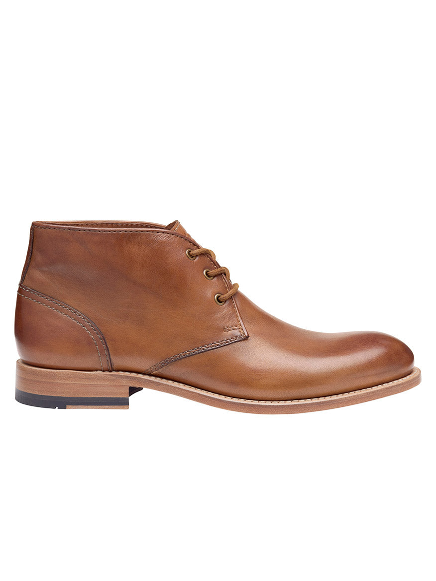 J & M Collection Dudley Chukka in Tan Dip-Dyed Calfskin is a tan, dip-dyed, calfskin leather ankle boot with lace-up design, low heel, and rubber sole, featuring a Goodyear welt. Viewed from the side.