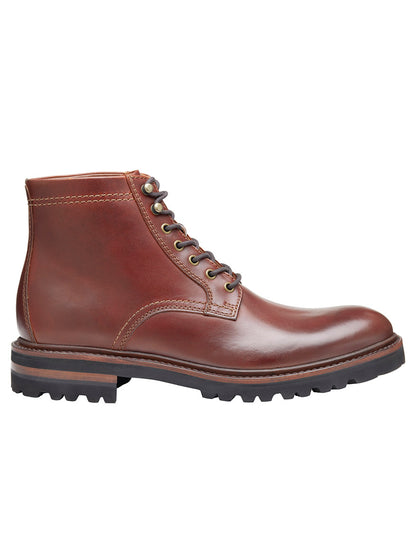 A side view of the J & M Collection Dudley Lug Plain Toe Boot in mahogany full grain, featuring vegetable tanned leather, lace-up design, Goodyear welt construction, and a black rubber sole.