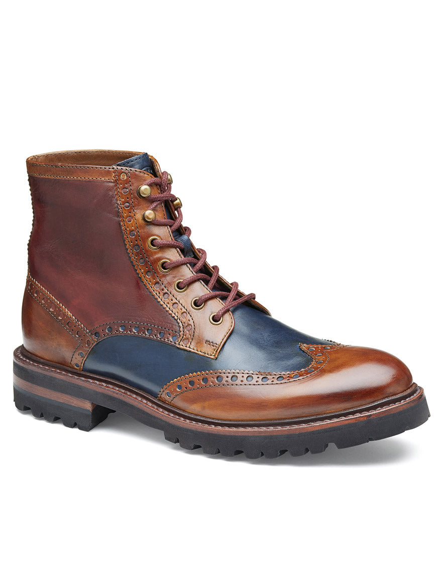 The J & M Collection Dudley Lug Wingtip Boot in Tan Multi Calfskin is a multi-colored leather brogue boot with decorative perforations, a lace-up front, and a thick EVA outsole, featuring Goodyear welt construction.