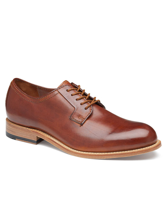 A single J & M Collection Dudley Plain Toe in Tan Dip-Dyed Calfskin dress shoe with laces on a white background.