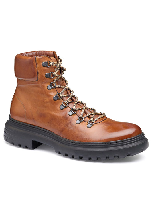 The J & M Collection Everson Alpine Boot in Tan Italian Calfskin is a handcrafted leather hiking boot with black laces and a thick black rubber sole, featuring a cushioned footbed for extra comfort, displayed against a white background.