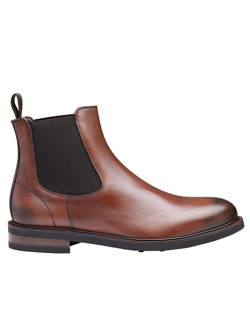 The J & M Collection Hartley Chelsea Boot in brown Italian calfskin is a single Chelsea boot featuring black elastic side panels, a pull tab on the heel, and a supple leather lining. The side view showcases its durability with a Vibram® EVA outsole.