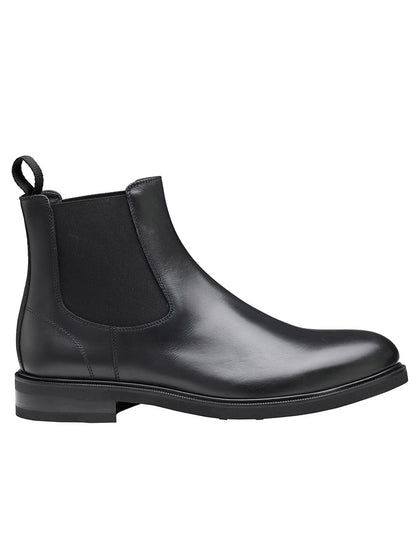 The J & M Collection Hartley Chelsea Boot in Black Italian Calfskin features a black leather upper, an elastic side panel, a pull tab at the back, and a Vibram EVA outsole for enhanced comfort.