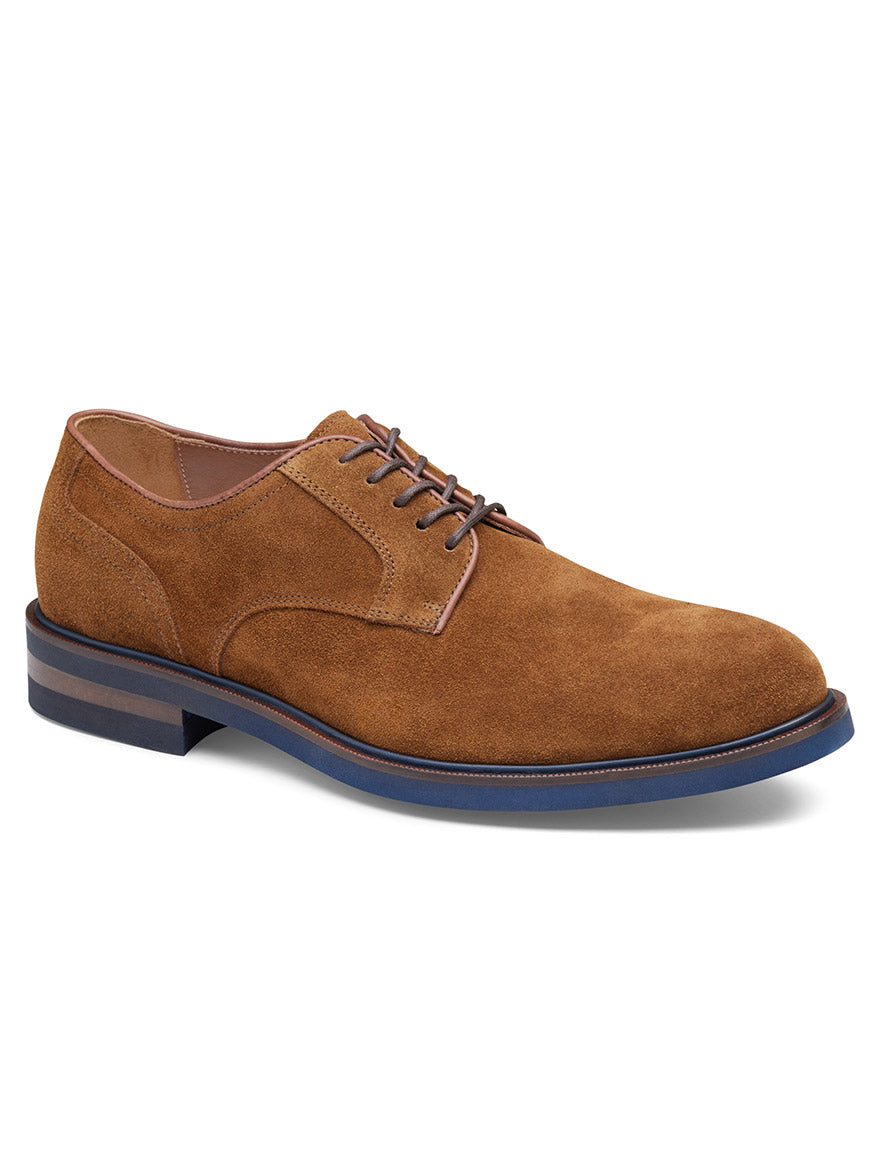 The J & M Collection Hartley Plain Toe in Snuff Italian Suede is showcased from a slightly elevated angle, highlighting its mocha brown suede upper, contrasting blue sole, and matching brown laces. It offers a comfortable leather lining and boasts a durable Vibram EVA outsole.