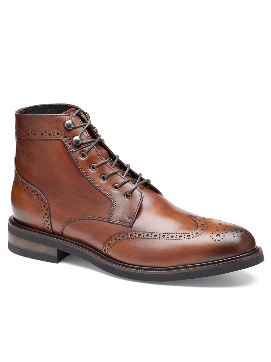 The J & M Collection Hartley Wingtip Boot in Brown Hand-Stained Calfskin features polished brown leather with decorative perforations, metal eyelets, laces, and a Vibram EVA outsole.