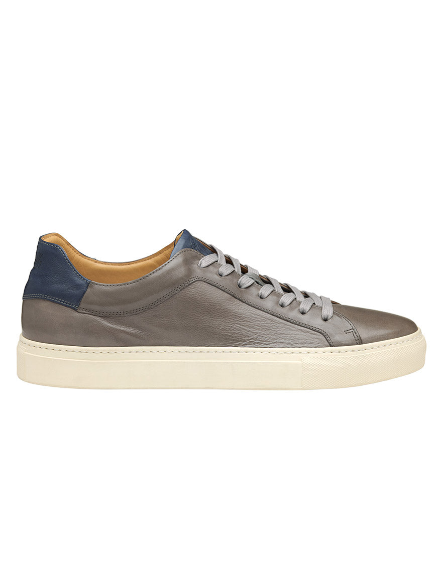 A single J & M Collection Jared Lace-To-Toe in Grey Italian Calfskin sneaker with blue heel tab and beige sole.