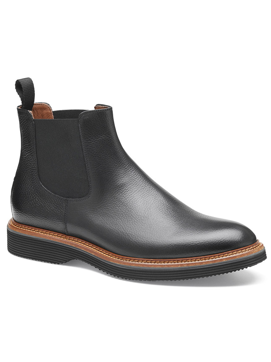 The J & M Collection Jenson Chelsea Boot in Black Tumbled Calfskin features a black leather design with a brown welt, black elastic side panels, a pull tab at the back, a leather-covered footbed, and a high-abrasion EVA outsole.