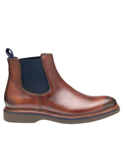 The J & M Collection Jenson Chelsea Boot in Brown Hand-Stained Calfskin features a European calfskin upper with a dark elastic side panel and pull tab. The boot has a round toe and an XL EXTRALIGHT outsole for added comfort and durability.