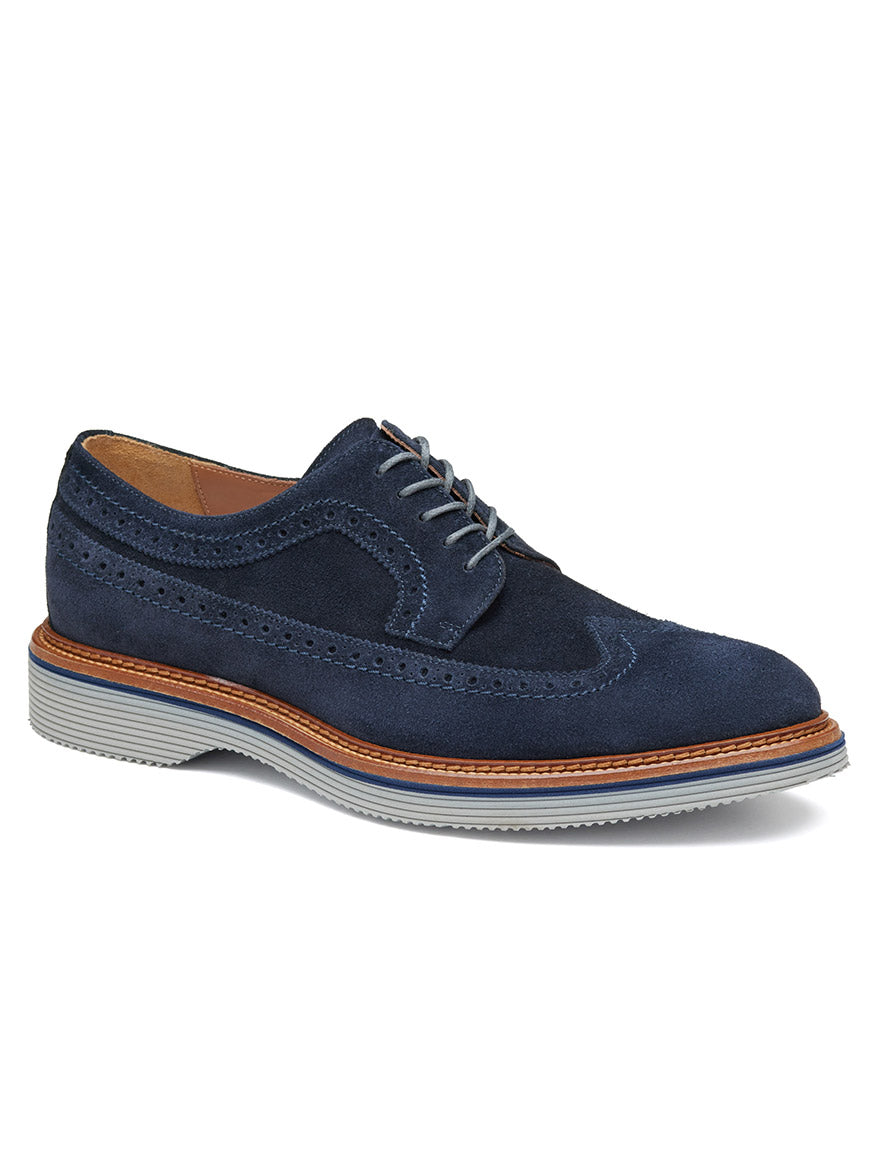 Introducing the J & M Collection Jenson Longwing in Navy Suede: a dark blue European suede brogue shoe adorned with grey laces, complemented by brown trim around the sole. It features a leather-covered footbed and a grey XL EXTRALIGHT® outsole for ultimate comfort and style.